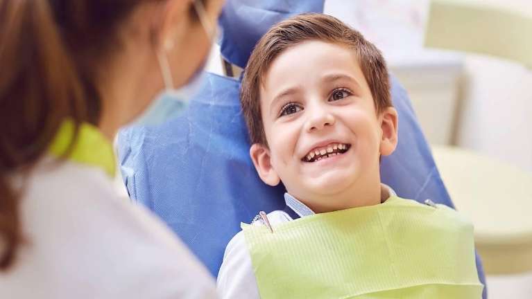 A smiling child getting a dental exam | Dentist Jonesboro